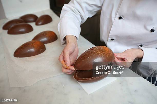 Head chocolatier Chika Watanabe creates handmade Easter eggs in the 'Melt' chocolate shop in Notting Hill on March 28, 2013 in London, England....