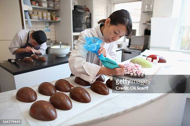 Head chocolatier Chika Watanabe creates handmade Easter eggs in the 'Melt' chocolate shop in Notting Hill on March 28, 2013 in London, England....