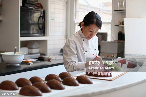 Head chocolatier Chika Watanabe creates handmade Easter eggs in the 'Melt' chocolate shop in Notting Hill on March 28, 2013 in London, England....