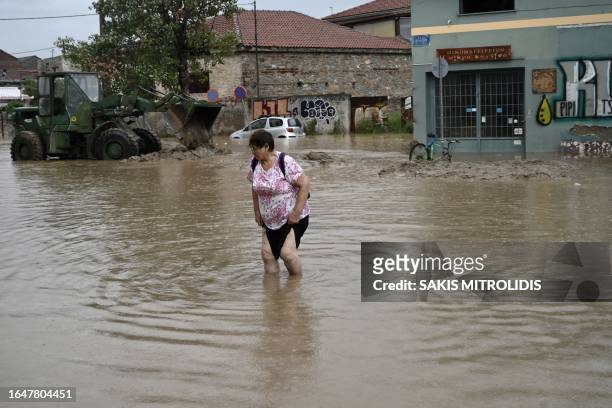 Local resident walks in a flooded street in Volos, central Greece, on September 6, 2023. The regional capital Volos has seen 200 millimetres of rain,...