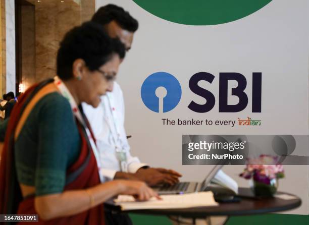 People work in front of a State Bank of India logo at the Global Fintech Fest in Mumbai, India, 05 September, 2023.