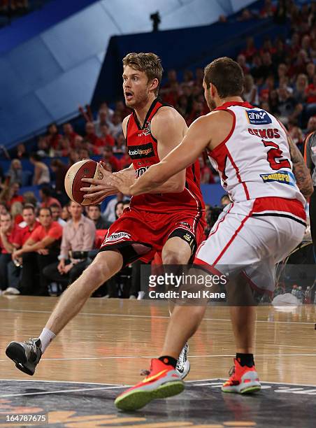 Cameron Tovey of the Wildcats drives into the key against Tyson Demos of the Hawks during game one of the NBL Semi Final Series between the Perth...