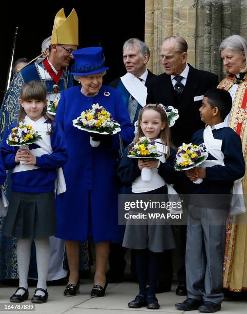 Queen Elizabeth II and Prince Phillip, Duke of Edinburgh pose with children after attending the Maundy service, at Christ Church Cathedral on March...