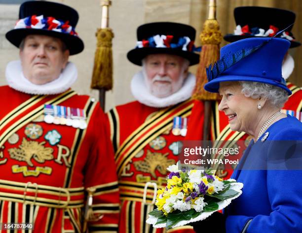 Queen Elizabeth II smiles as she walks past Yeoman of the Guard, after attending the Maundy service, at Christ Church Cathedral on March 28, 2013 in...