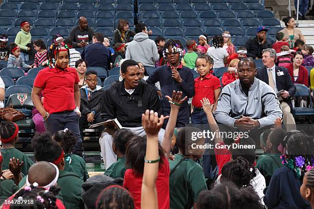 Brandon Jennings of the Milwaukee Bucks and assistant coach Anthony Goldwire read stories and answer questions during the Bucks and Sam's Hope...