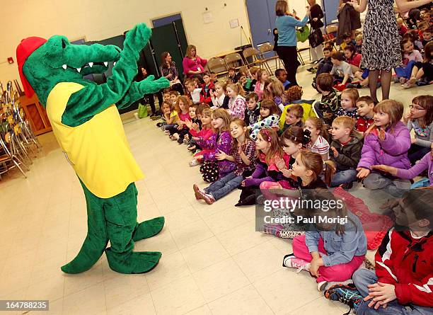 Mascot Al E. Gator excites students at a school assembly to celebrate the Scott Shared Values Sweepstakes award of $25,000 to Youth's Benefit...