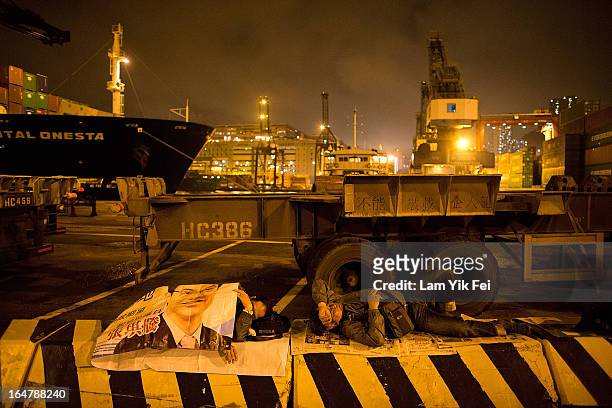 Dock workers stage a sit-in as they go on strike over pay at the Kwai Chung Container Terminal on March 28, 2013 in Hong Kong, China. The workers,...