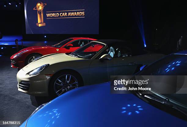 Porsche Boxster/Cayman is displayed with other sports cars after being named the 2013 World Performance Car of the Year at the New York Auto Show on...