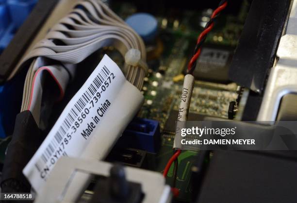 This picture taken on March 28, 2013 in Rennes, western France shows a sticker reading ''Made in China'' on a computer's motherboard. AFP PHOTO...