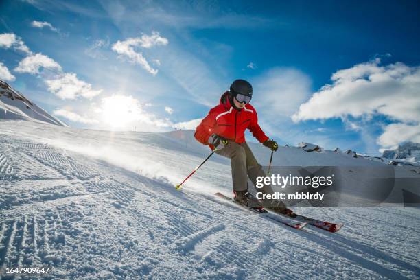 young skier downhill skiing at zermatt ski resort, switzerland - ski stock pictures, royalty-free photos & images