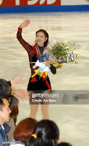 Second-placed Shizuka Arakawa waves to the fan during an award ceremony for women's singles at Japan International Challenge figure skating cup...