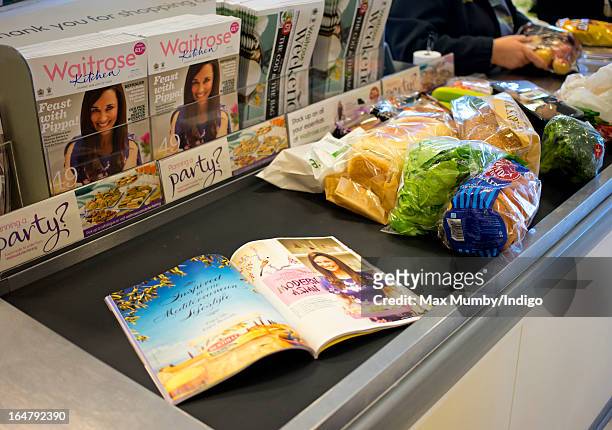 In this photo illustration the latest edition of Waitrose Kitchen Magazine, featuring Pippa Middleton on the cover, seen on a till conveyor belt in a...