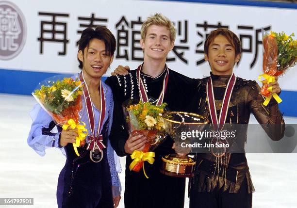 "Winner Jeffrey Buttle , second-placed Daisuke Takahashi and third-placed Nobunari Oda during an award ceremony for men's singles at Japan...