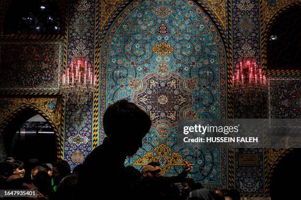 Shiite Muslim devotees gather inside the Shrine of Imam Hussein, the Prophet Mohammed's grandson, in Iraq's central holy city of Karbala on September...