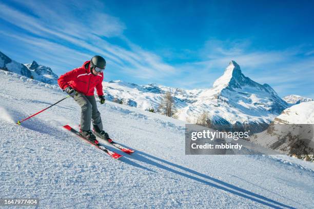 young skier downhill skiing at zermatt ski resort, switzerland - cantão de valais imagens e fotografias de stock
