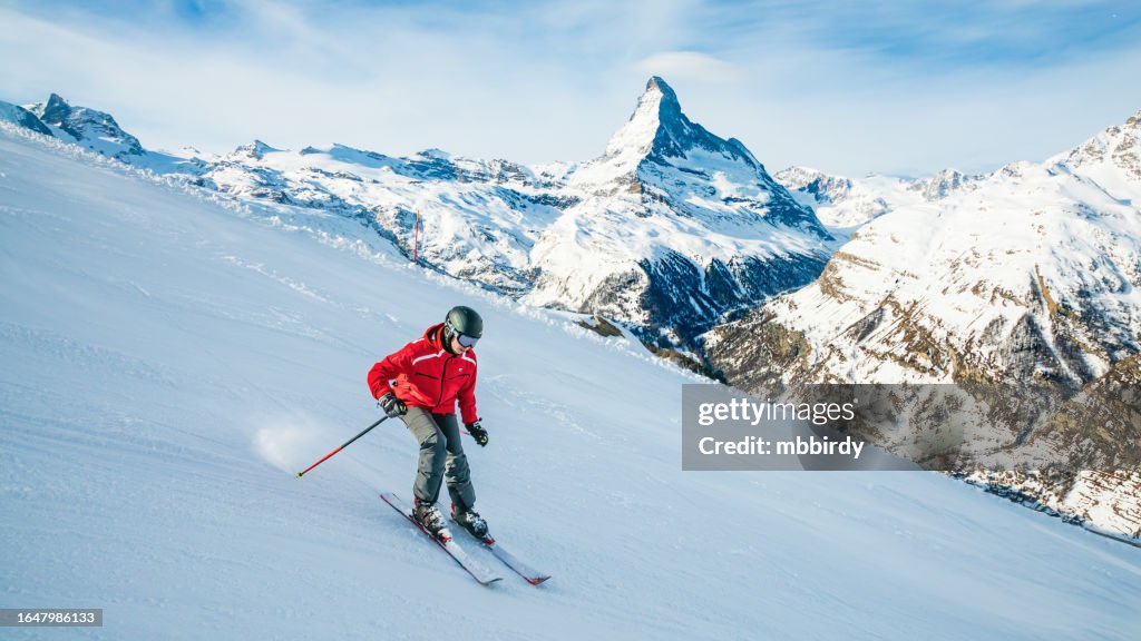 Young skier downhill skiing at Zermatt ski resort, Switzerland
