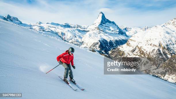 young skier downhill skiing at zermatt ski resort, switzerland - zermatt skiing stock pictures, royalty-free photos & images