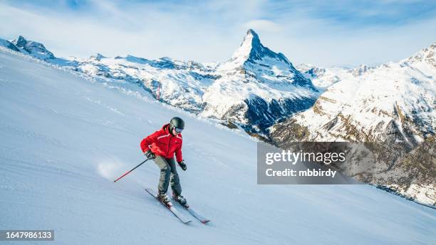 young skier downhill skiing at zermatt ski resort, switzerland - skidåkning bildbanksfoton och bilder