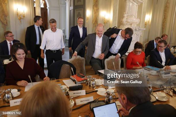German Chancellor Olaf Scholz convenes the second of a two-day retreat of the German federal government cabinet at Schloss Meseberg on August 30,...