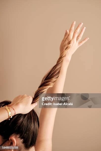 woman combing her hair with her hands - brown hair with highlights stock pictures, royalty-free photos & images