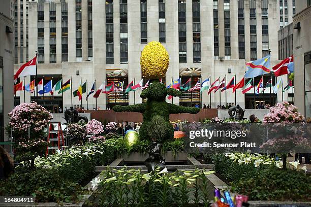 Foot tall Easter bunny topiary stands among white Easter lilies before the upcoming Easter holiday in Rockefeller Center on March 28, 2013 in New...