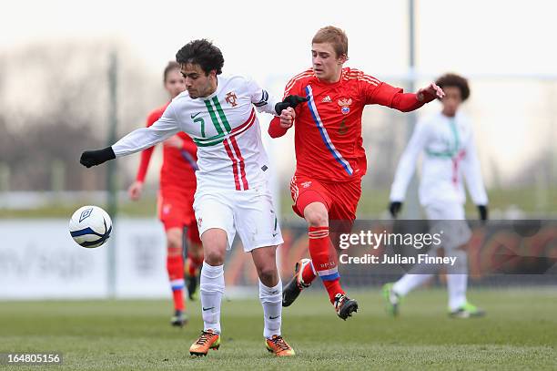 Sergio Ribeiro of Portugal holds off Dmitriy Barinov of Russia during the UEFA European Under-17 Championship Elite Round match between Russia and...