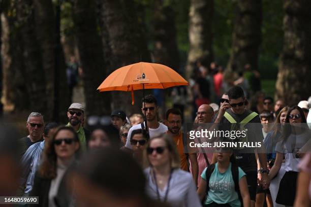 Group of tourists follow a tour guide in central London on September 6, 2023 as the late summer heatwave continues.