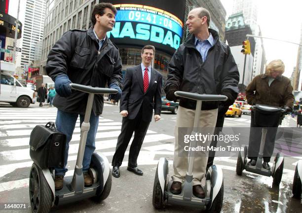 Amazon.com CEO Jeff Bezos stands on a Segway with Segway inventor Dean Kamen and NASDAQ Vice Chairman David Weild after opening the NASDAQ Stock...