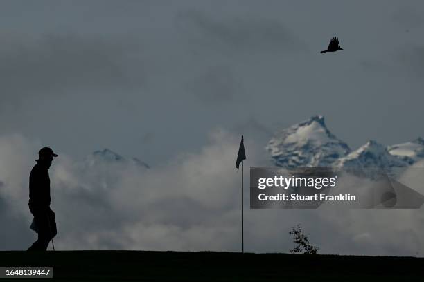 Nicolai Hojgaard of Denmark walks on the seventh green as a bird flys by during the pro-am prior to the start of the Omega European Masters at...