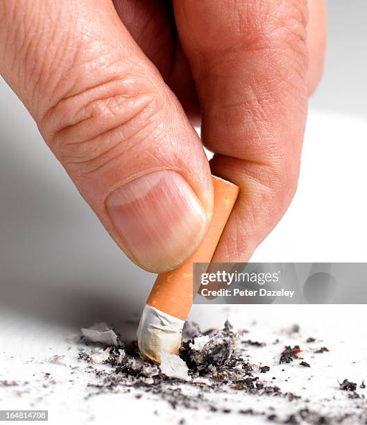 giving up smoking for new year - stubbing out cigarette stock pictures, royalty-free photos & images