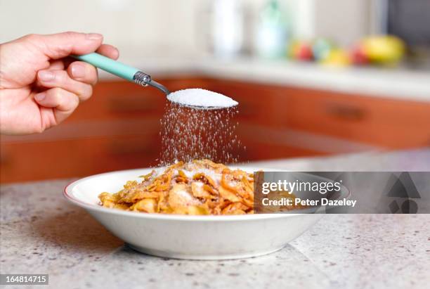 putting to much sugar on corn flakes - zucker stock-fotos und bilder