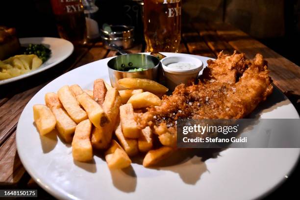Close Up of the typical English dish Fish and Chips inside a pub on August 23, 2023 in London, England. London is the capital of England, many of the...