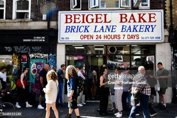 General view of people attends in front of Sandwich Bagel street food on Brick Lane on August 23, 2023 in London, England. London is the capital of...