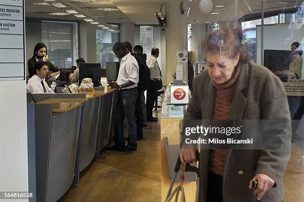 Fewer customers as expected queue for service in a Laiki Bank branch as the country's banks re-open following 12 days of closure on March 28, 2013 in...