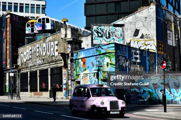 General view of graffiti on walls in Bethnal Green Road near Brick Lane on August 23, 2023 in London, England. London is the capital of England, many...