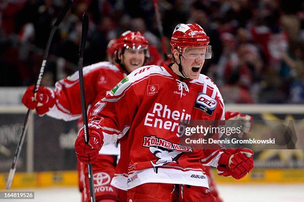 Philip Gogulla of Koeln celebrates after scoring the winning goal in game five of the DEL play-offs between Koelner Haie and Straubing Tigers at...