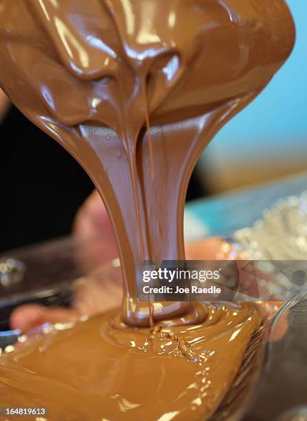 Darlene Eddy pours chocolate into a mold to make a chocolate Easter bunny in her store Amazing Chocolates on March 28, 2013 in Hollywood, Florida....