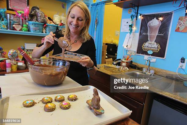 Darlene Eddy pours chocolate into a mold to make a chocolate Easter bunny in her store Amazing Chocolates on March 28, 2013 in Hollywood, Florida....