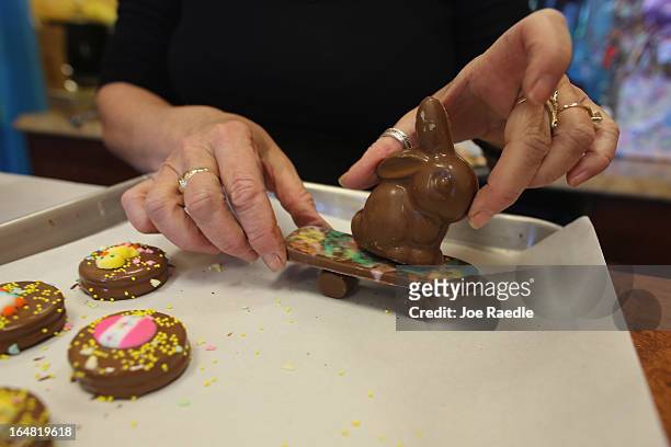 Darlene Eddy handles a skateboarding chocolate Easter bunny in her store Amazing Chocolates on March 28, 2013 in Hollywood, Florida. Americans spend...