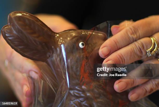 Darlene Eddy packages up a chocolate Easter bunny that she made in her store Amazing Chocolates on March 28, 2013 in Hollywood, Florida. Americans...