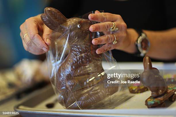 Darlene Eddy packages up a chocolate Easter bunny that she made in her store Amazing Chocolates on March 28, 2013 in Hollywood, Florida. As Easter...