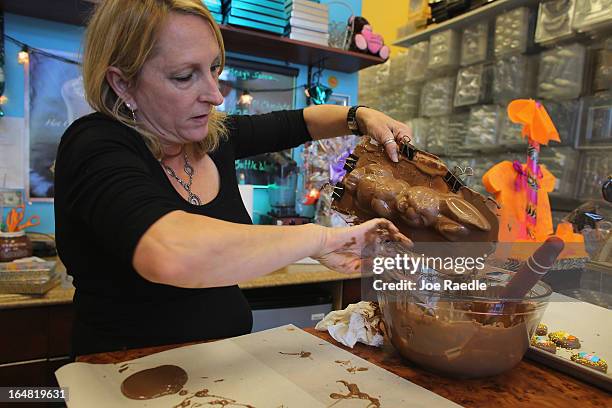 Darlene Eddy uses a mold to make a chocolate Easter bunny in her store Amazing Chocolates on March 28, 2013 in Hollywood, Florida. Americans spend...