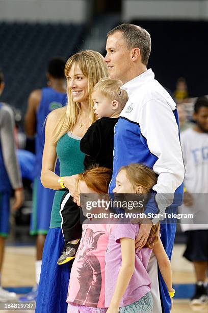 Florida Gulf Coast head coach Andy Enfield and his wife, Amanda, join daughters Aila and Lily and son Marcum for a photo during practice at Cowboys...