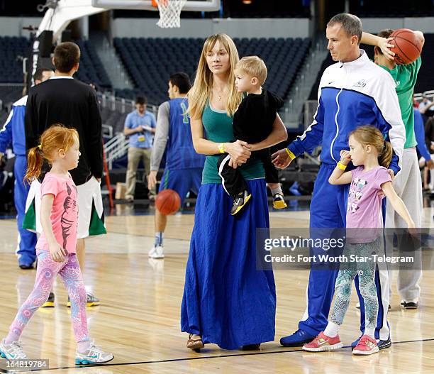 Florida Gulf Coast head coach Andy Enfield and his wife, Amanda, along with daughters Aila and Lily and son Marcum, step onto the court for a photo...