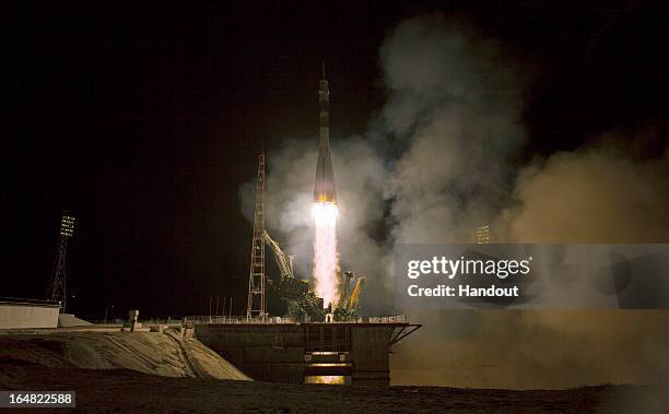 In this handout image provided by NASA, the Soyuz TMA-08M rocket launches from the Baikonur Cosmodrome carrying Expedition 35 Russian Flight Engineer...