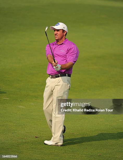 Scott Hend of Australia plays a shot during round one of the Chiangmai Golf Classic at Alpine Golf Resort-Chiangmai on March 28, 2013 in Chiang Mai,...