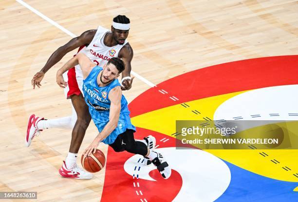 Slovenia's Aleksej Nikolic dribbles past Canada's Shai Gilgeous-Alexander during the FIBA Basketball World Cup quarter-final match between Canada and...