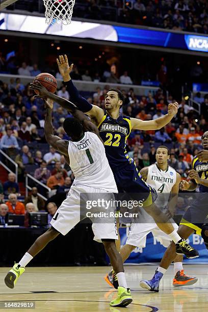 Trent Lockett of the Marquette Golden Eagles goes up for the block against Durand Scott of the Miami Hurricanes during the East Regional Round of the...