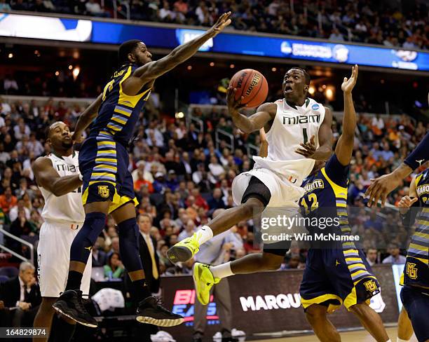 Durand Scott of the Miami Hurricanes goes to the hoop against Jamil Wilson of the Marquette Golden Eagles during the East Regional Round of the 2013...