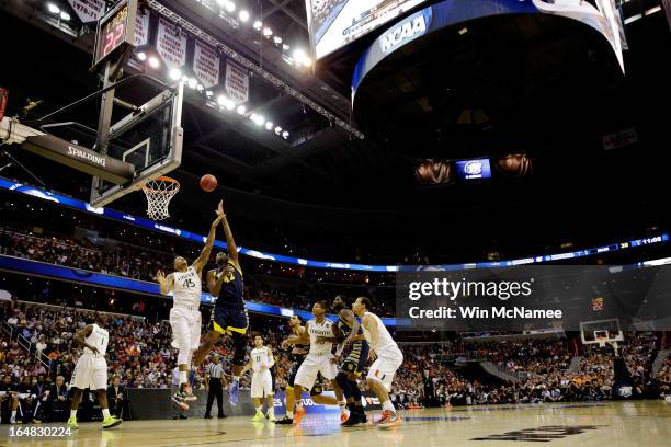 Chris Otule of the Marquette Golden Eagles shoots the ball over Julian Gamble of the Miami Hurricanes during the East Regional Round of the 2013 NCAA...